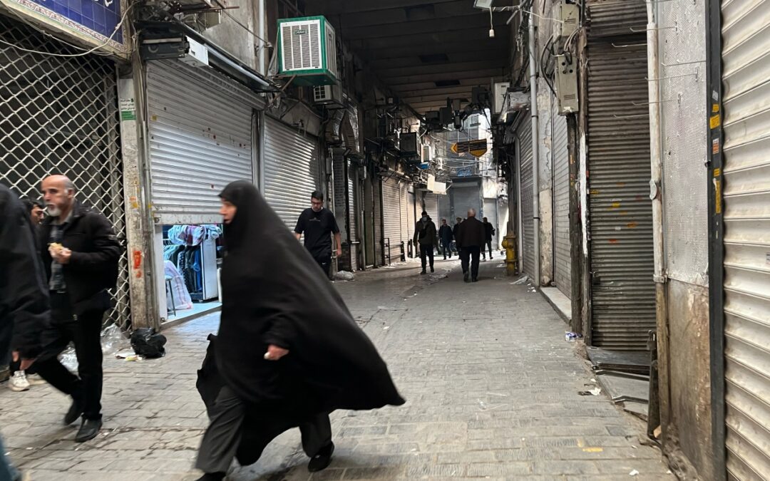 Security forces clash with protesters in Iran's main market as death toll rises